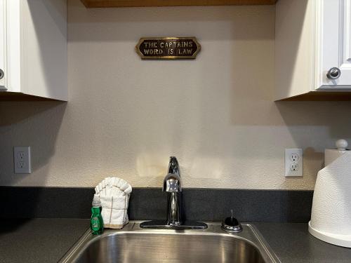 a kitchen sink with a sign that says the drinking must be thirsty at Inn at the Sea in Long Beach