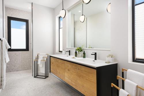 a bathroom with a sink and a mirror at Upper East Side Enclave # 18 in Leeward