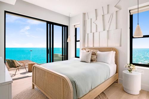 a bedroom with a bed with a view of the ocean at Villa Julia and Villa Angelina in Leeward