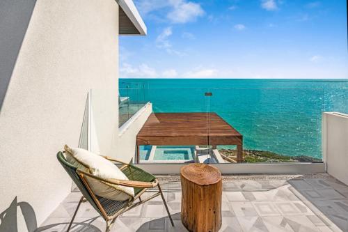 a balcony with a view of the ocean at Villa Julia and Villa Angelina in Leeward