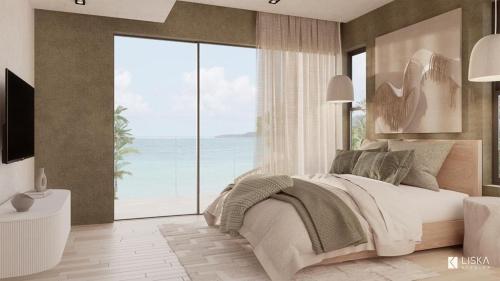 a bedroom with a bed with a view of the ocean at Villa Julia and Villa Angelina in Leeward