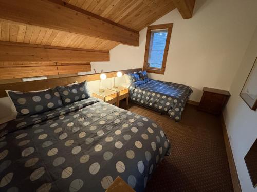 a bedroom with two beds and a window at Timber Creek 309 condo in Truckee