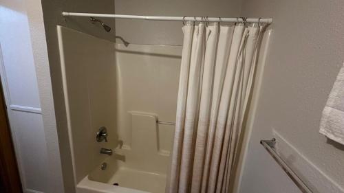 a bathroom with a shower with a shower curtain at Cozy town house in Wall! in Wall