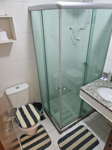 a bathroom with a glass shower with a toilet and a sink at Multiplex Unique DOCA cop30 in Belém