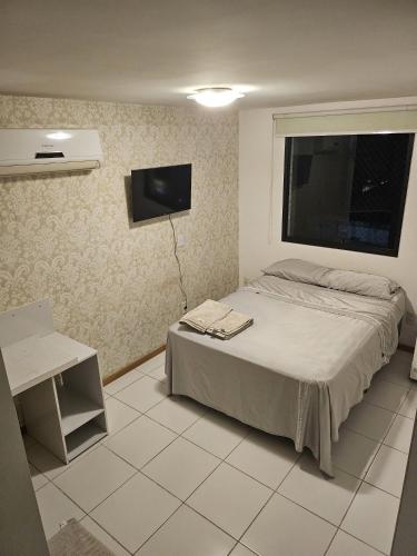 a bedroom with a bed and a flat screen tv at Multiplex Unique DOCA cop30 in Belém