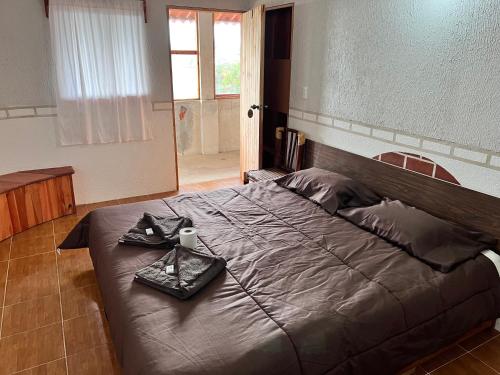 a bedroom with a large bed with a tray on it at Posada Quetzalin in Cuetzalán del Progreso