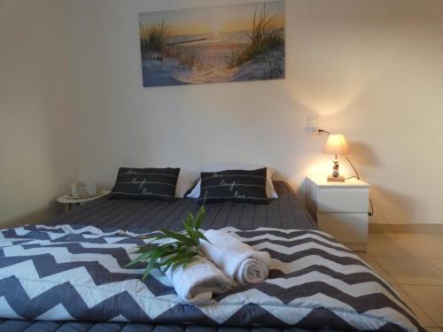 une chambre avec un lit avec une couverture dessus dans l'établissement Maison vacances Fromentine 4 pers, véranda, animaux admis, jardin, parking - FR-1-540-309, à La Barre-de-Monts