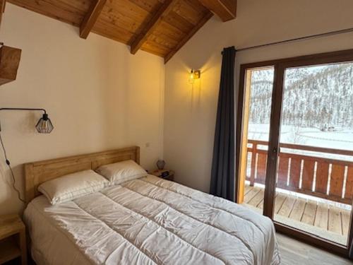 une chambre avec un lit et une grande fenêtre dans l'établissement Superbe duplex montagnard luxe pour 6 pers. à Montgenèvre - FR-1-445-214, à Montgenèvre