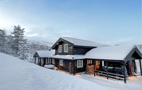 a house with snow on the roof of it at 4 Bedroom Cozy Home In Norheimsund in Norheimsund