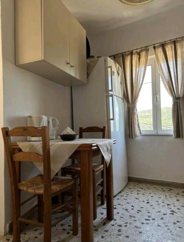 a kitchen with a table and chairs and a window at Dreamcatcher in Makrikhórion