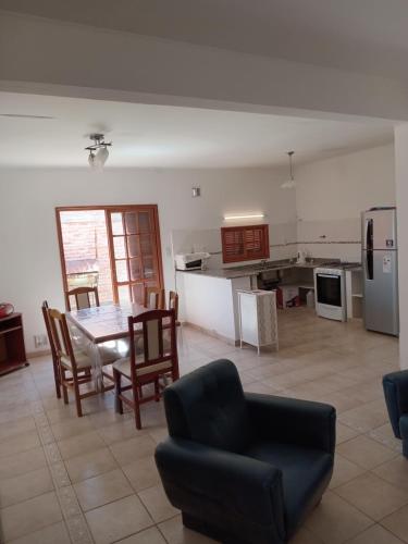 a kitchen and living room with a table and chairs at La huella del cacique in Catriel