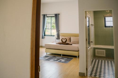 a bedroom with a bed and a walk in shower at Chor Grande Resort in Trat