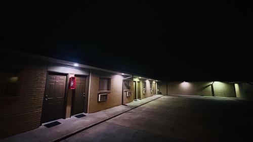 a dark alley with a row of doors at night at Relax Inn by OYO Sulphur Hwy 90 in Sulphur