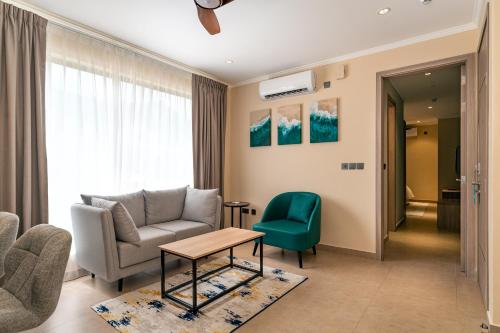 a living room with a couch and a chair at Thalassa Seychelles in Beau Vallon