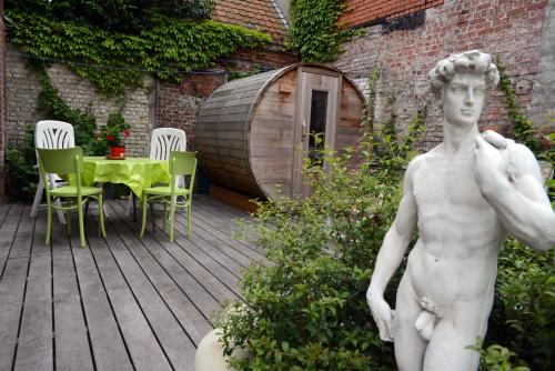 a statue of a man standing on a wooden deck at R&breakfast in Roeselare