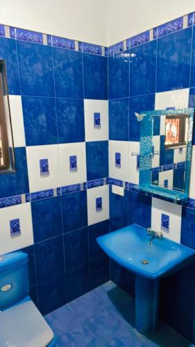 a blue bathroom with a sink and a toilet at Luxe Living in Wennappuwa