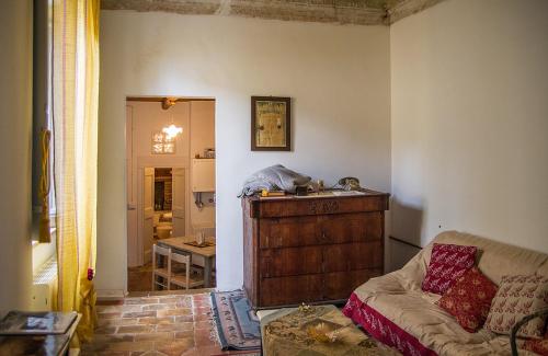 a living room with a couch and a table at La Neviera Nel Pozzo in Offida