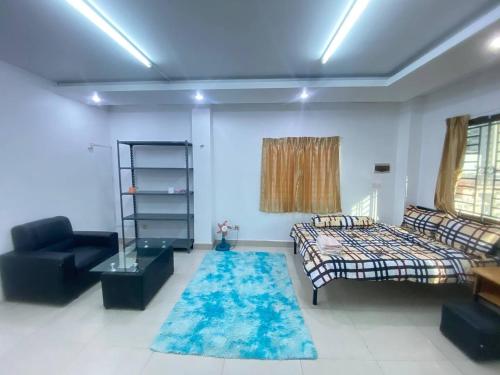 a living room with a bed and a couch at The Moonvine on 360 in Phnom Penh