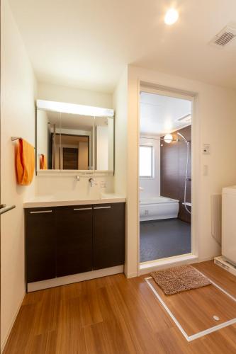 a bathroom with a sink and a mirror at Cozy house! 4 Mins from Hisaya-Odori station in Nagoya