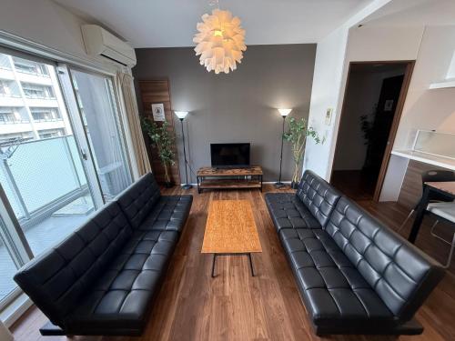 a living room with a couch and a table at Cozy house! 4 Mins from Hisaya-Odori station in Nagoya