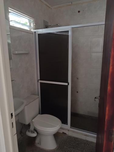 a small bathroom with a toilet and a shower at PasajeHome in Resistencia