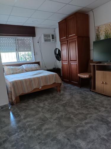Ένα ή περισσότερα κρεβάτια σε δωμάτιο στο PasajeHome