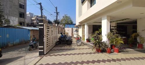 a group of motorcycles parked next to a building at Hotel Asian Inn, Nagpur in Nagpur