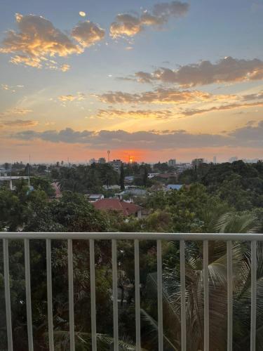 a view of a sunset from a balcony at Wonder Nest Dar es salaam in Dar es Salaam