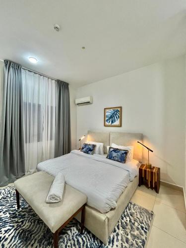 a bedroom with a large bed and a window at Wonder Nest Dar es salaam in Dar es Salaam