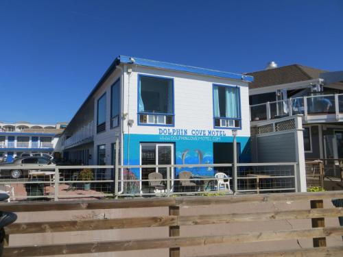 a building with a sign that reads dolphin soup patch at Dolphin Cove Motel in Pismo Beach