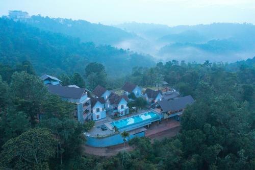 an aerial view of a house in a forest at Vbrings Oak Village in Munnar
