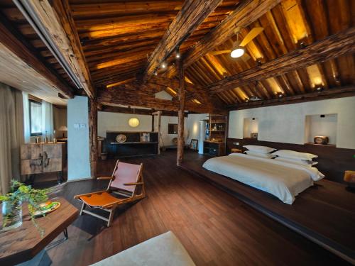 a bedroom with a large bed and a wooden ceiling at Kong Garden Designer Hotel in Dali Ancient Town