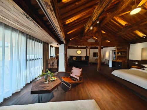 a bedroom with a bed and a couch and a table at Kong Garden Designer Hotel in Dali Ancient Town