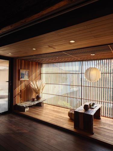 a room with wooden floors and a large window at Kong Garden Designer Hotel in Dali Ancient Town