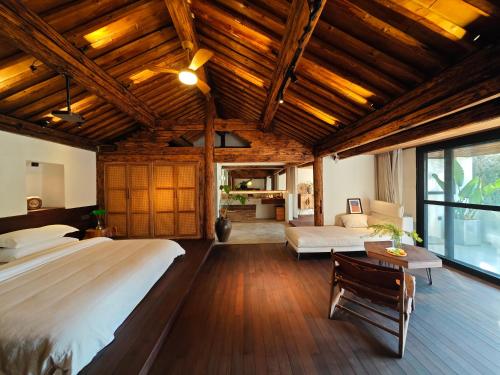 a bedroom with a large bed and a living room at Kong Garden Designer Hotel in Dali Ancient Town