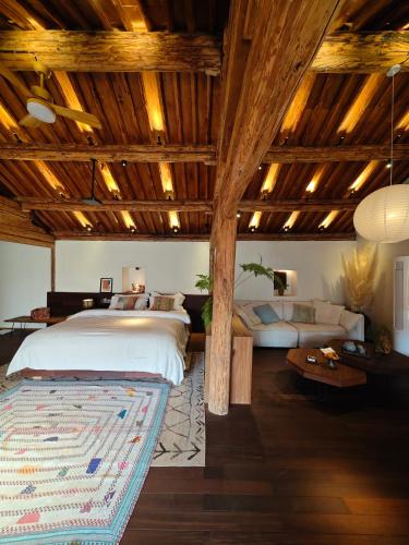 a bedroom with a large bed and a couch at Kong Garden Designer Hotel in Dali Ancient Town