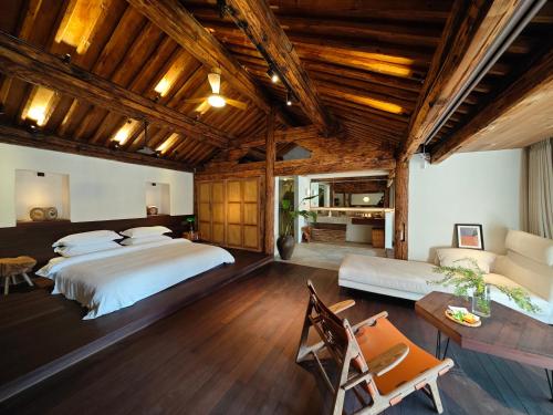 a bedroom with a large bed and a couch at Kong Garden Designer Hotel in Dali Ancient Town