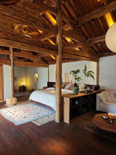 a bedroom with a large bed with wooden ceilings at Kong Garden Designer Hotel in Dali Ancient Town