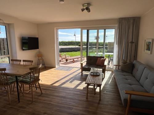 a living room with a couch and a table at Ostsee-Strandhaus-Holnis in Glücksburg