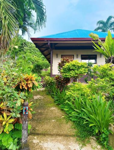 a house with a garden in front of it at Casa Rosa Inn and Restaurant in Taytay