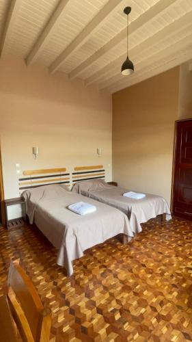 a room with three beds in a room at Excellentia Antsirabe in Antsirabe