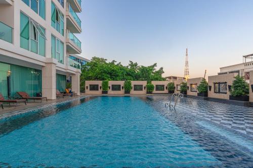 a swimming pool in the middle of a building at City Garden Tower by Pattaya Holiday in Pattaya South