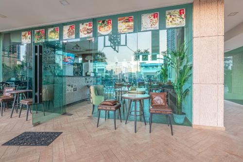 a restaurant with chairs and tables in a building at City Garden Tower by Pattaya Holiday in Pattaya South