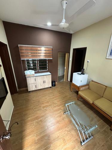 a living room with a couch and a table at Santai Salai Homestay and Cafe in Kepala Batas