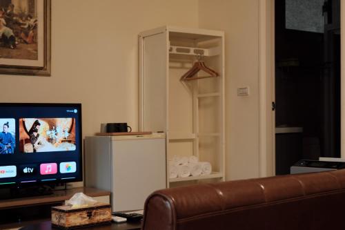 a living room with a couch and a television at Heidisuitcase Homestay in Hualien City