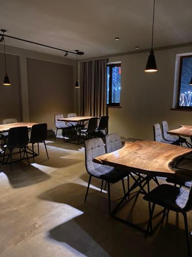 a conference room with tables and chairs and lights at Ani Hotel in Maralik