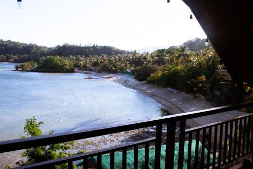 a view of a beach from a balcony at MegaBuena Beach Resort in Mansalay