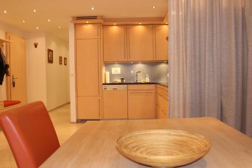 a kitchen with a table with a bowl on top of it at Laax Rancho Residence in Laax