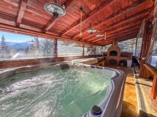 a hot tub in the middle of a house at Cabana Raza Soarelui in Beliş