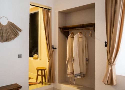 a room with a closet with curtains and a stool at Notarius Hotel Bodrum in Bodrum City